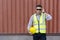 Caucasian Container Worker with Hard Hat Wearing Eyeglasses