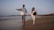 Caucasian couple in casual clothes resting relax holding hand walking beach honeymoon. Young family together happy