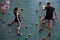 Caucasian couple climbers. Extreme indoor climbing. Strong woman and man
