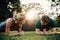 Caucasian couple doing core workout in park