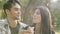 Caucasian couple eating, bonding, sharing a piece of a pizza pie, laughing. Enjoying a meal while on a date together in