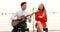 Caucasian couple playing guitar and singing a song