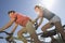 Caucasian Couple Riding Tandem Bicycle