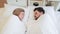 Caucasian couple sleeping face to face in bed