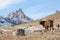 Caucasian cows grazing on winter pastures on the gold background of the majestic rocks