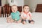 Caucasian cute adorable funny baby boys sitting together on bed