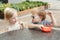 Caucasian cute adorable funny children toddlers sitting together sharing eating food