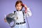 Caucasian displeased child is dressed in an astronaut costume