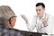 Caucasian doctor talking with aged patient