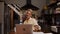 Caucasian elderly woman working from home in kitchen