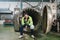 Caucasian engineer man in safety uniform sitting and reporting on processing large duct contrainer in industry manufacturing