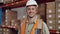 Caucasian engineer smiling wearing hard hat in packaging factory