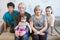 Caucasian family with teen age children, infant child and senior parents sitting on a sofa at home. Happy and relaxing family