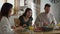 Caucasian family of three sharing breakfast food together.