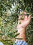 Caucasian farmer checks the unripe olives. Agriculture