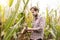Caucasian farmer in plaid shirt control corn field