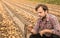 Caucasian farmer in plaid shirt control onion field