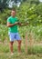 Caucasian farmer by a young walnut tree