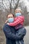 Caucasian father with child girl wearing sanitary face masks outdoor. Family dad and daughter protect themselves from dangerous