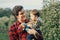 Caucasian father hugging playing with baby boy.