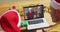 Caucasian father with son using laptop for christmas video call with smiling couple on screen