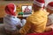 Caucasian father and sons in santa hats making laptop christmas group video call with santa claus