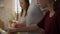 Caucasian father teaching daughter how cook the soup.