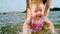 Caucasian female baby first time at sea, jump into water