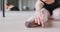 Caucasian female ballet dancer stretching up on the floor for dance class in a bright studio