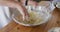 Caucasian female chef mixing dough in a bowl