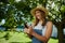 Caucasian female farmer smiling while texting on cellular device