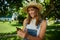 Caucasian female farmer texting on cellular device standing outdoors