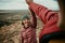 Caucasian female hiking with male high five after reaching mountain peak smiling