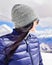 Caucasian female person enjoy winter mountains panorama in sunny ski resort. Right empty blank space copypaste winter solo holiday