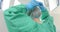 Caucasian female surgeon wearing surgical gown and cap in operating theatre, slow motion