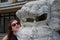Caucasian female tourist posing with white marble dragon lion statue in Japan