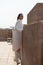 Caucasian female tourist standing on tower rooftop enjoying