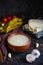 Caucasian first dish Khash Hash soup in bowl with scattered ingredients and spices on background