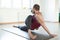 Caucasian fit man practice yoga indoor, lizard pose with spine twist exercise in fitness loft studio, selective focus.