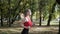Caucasian fitness girl runner in sportswear running at autumn park on sunny day