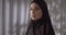 Caucasian girl black hijab neon make-up portrait light night white background