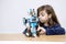 Caucasian girl constructing a Lego robot