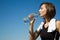 Caucasian girl drinking water after exercise