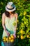 caucasian girl farming lemons with a green dress