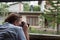 Caucasian girl making photos from train window while treavelling in Sri Lanka.