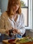 Caucasian girl in a modern kitchen, prepares some vegetables