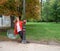 Caucasian girl with red coat plays with transparent umbrella next to a lamppost