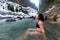 Caucasian Girl swimming in the Ice Cold Freezing Glacier River