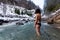 Caucasian Girl swimming in the Ice Cold Freezing Glacier River