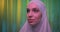 Caucasian girl white hijab neon make-up portrait light night background